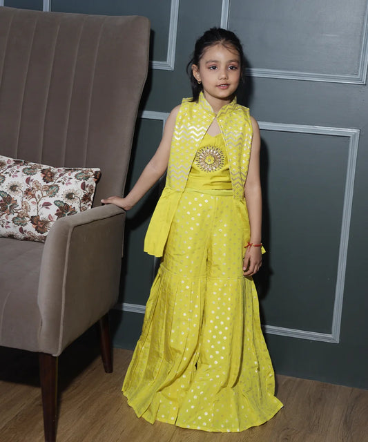 This yellow coloured baby girl sharara suit consists of a crop top, a sharara and a Jacket. It features embellished floral detailing on the crop top and pleated detailing on the Jacket.