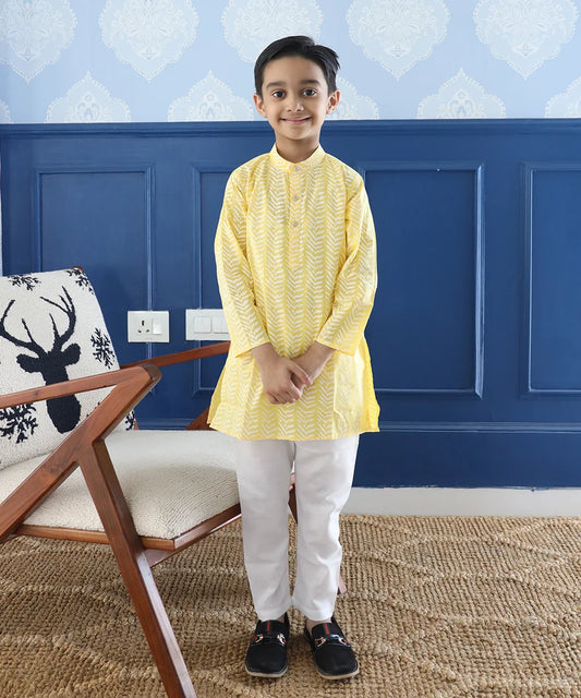 It is a light yellow Colored printed kurta teamed up with a pyjama, that has an elasticated waist. It's the best boy's designer kurta-pyjama set.