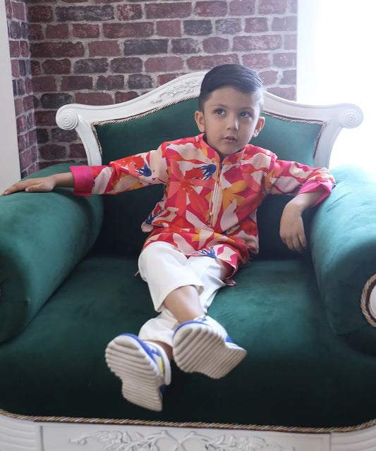 It is a multi-coloured printed kurta teamed up with a matching Pyjama for kids. It's the best boy's designer kurta-pyjama set.