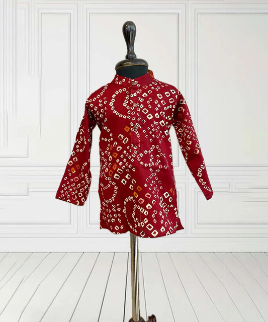  It is a maroon Coloured smart bhandej print kurta pyjama set that creates a spotlight of its own.