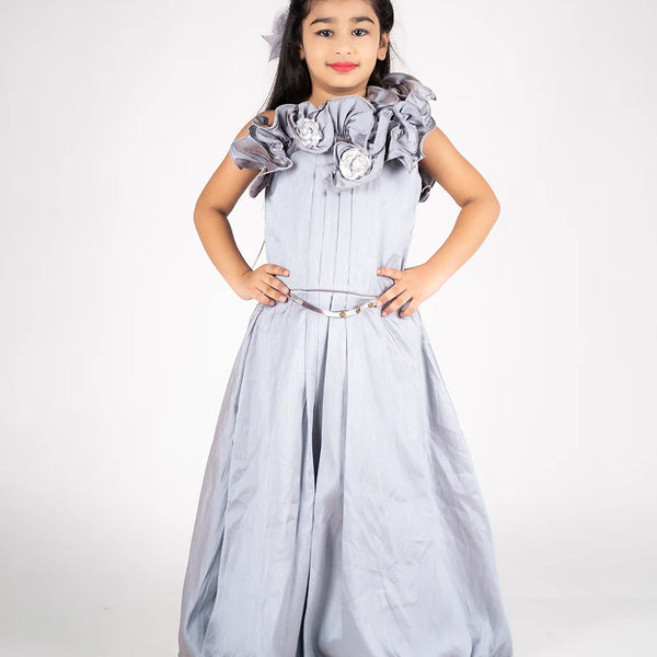 It is a  grey Colored gown paired up with a metallic Colored belt. It features floral and pleated detailing on the dress.