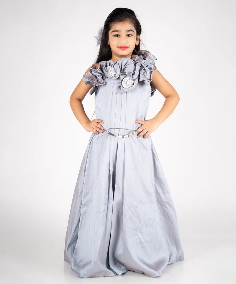 It is a  grey Colored gown paired up with a metallic Colored belt. It features floral and pleated detailing on the dress.