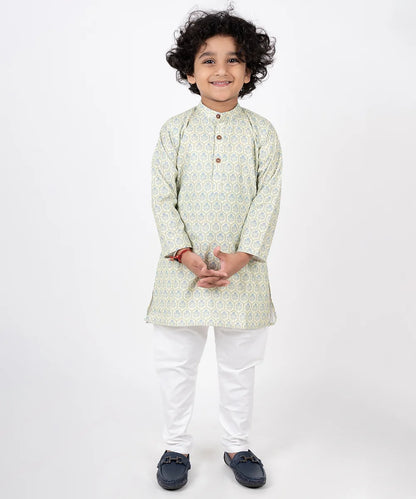 It is a beautiful pista green colored printed cotton Kurta paired with off-white Pajama for boys for party looks. It consists of a Kurta with the wooden button detailing and a matching Salwar.