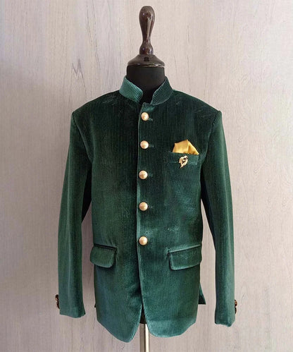 It is a beautiful bottle green rich velvet Jodhpuri for boys paired up with black color Pants. It is featured with a cute broach and a golden colour pocket square.