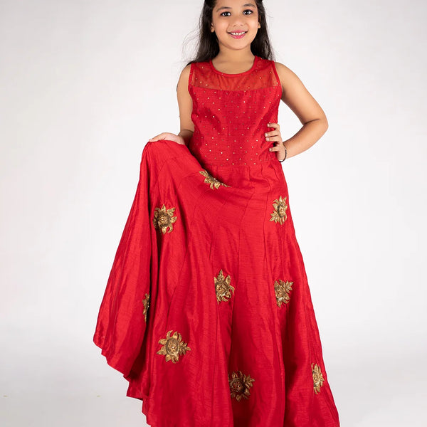 This is a red gown paired up with short sleeves that can be stitched as per requirement and comes with a back zip closure. It features Golden sequin and floral work detailing and comes with the fabric belt to be tied at the back.