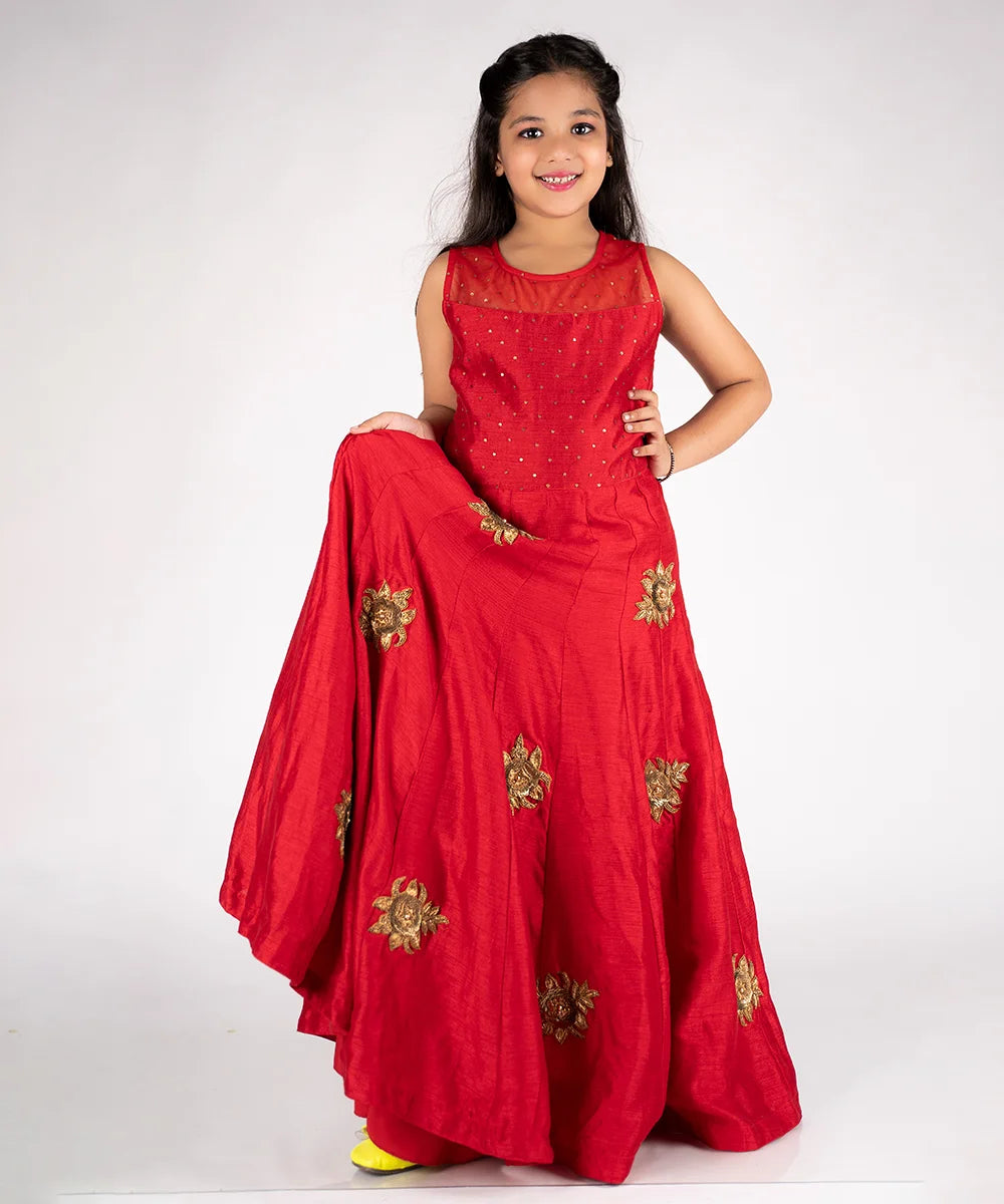 This is a red gown paired up with short sleeves that can be stitched as per requirement and comes with a back zip closure. It features Golden sequin and floral work detailing and comes with the fabric belt to be tied at the back.