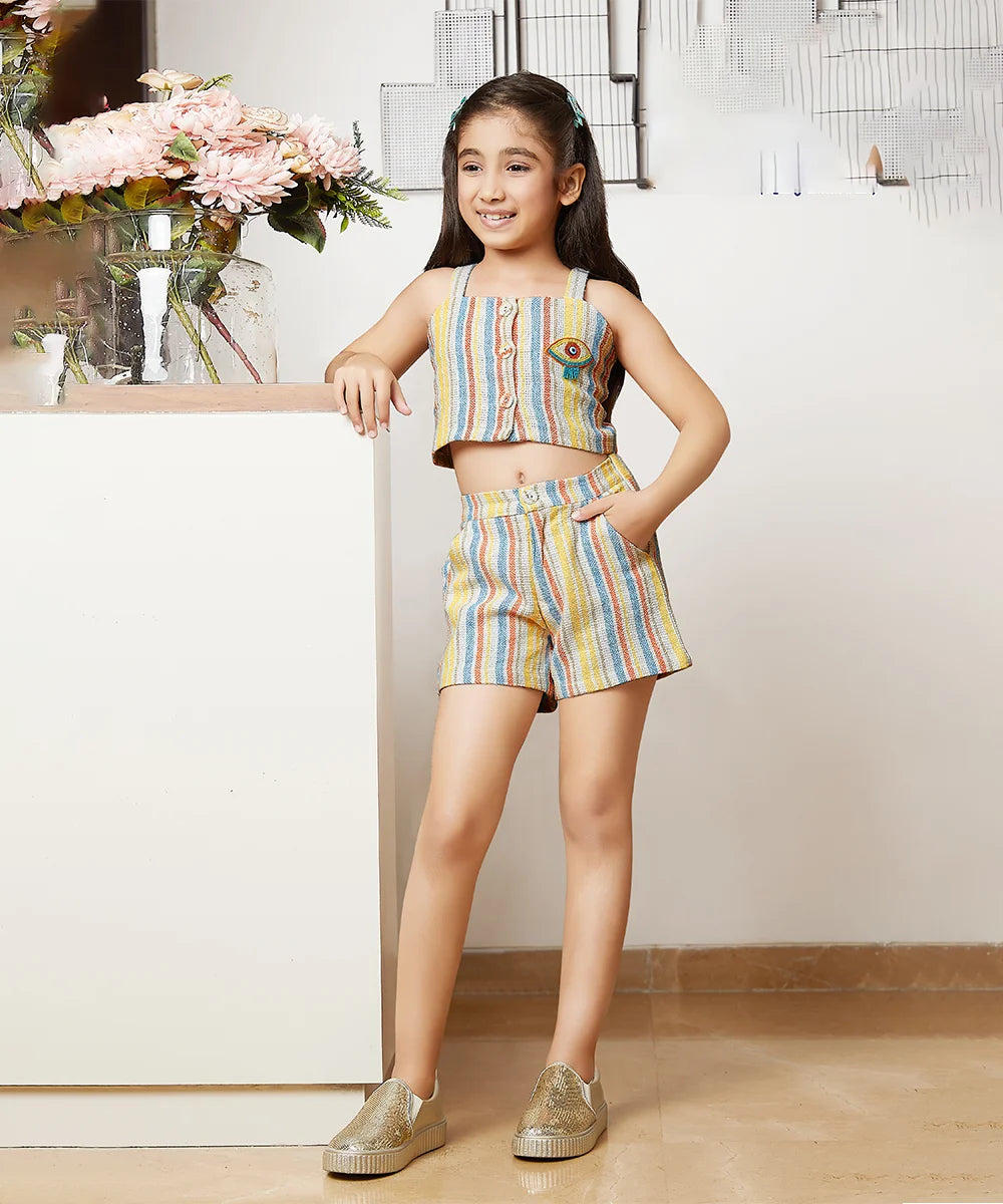 It Consists of a self-striped front closure multi colored crop top and matching shorts. The top has a beautiful beaded motif detailing on it and the shorts come with a pocket on all four sides.