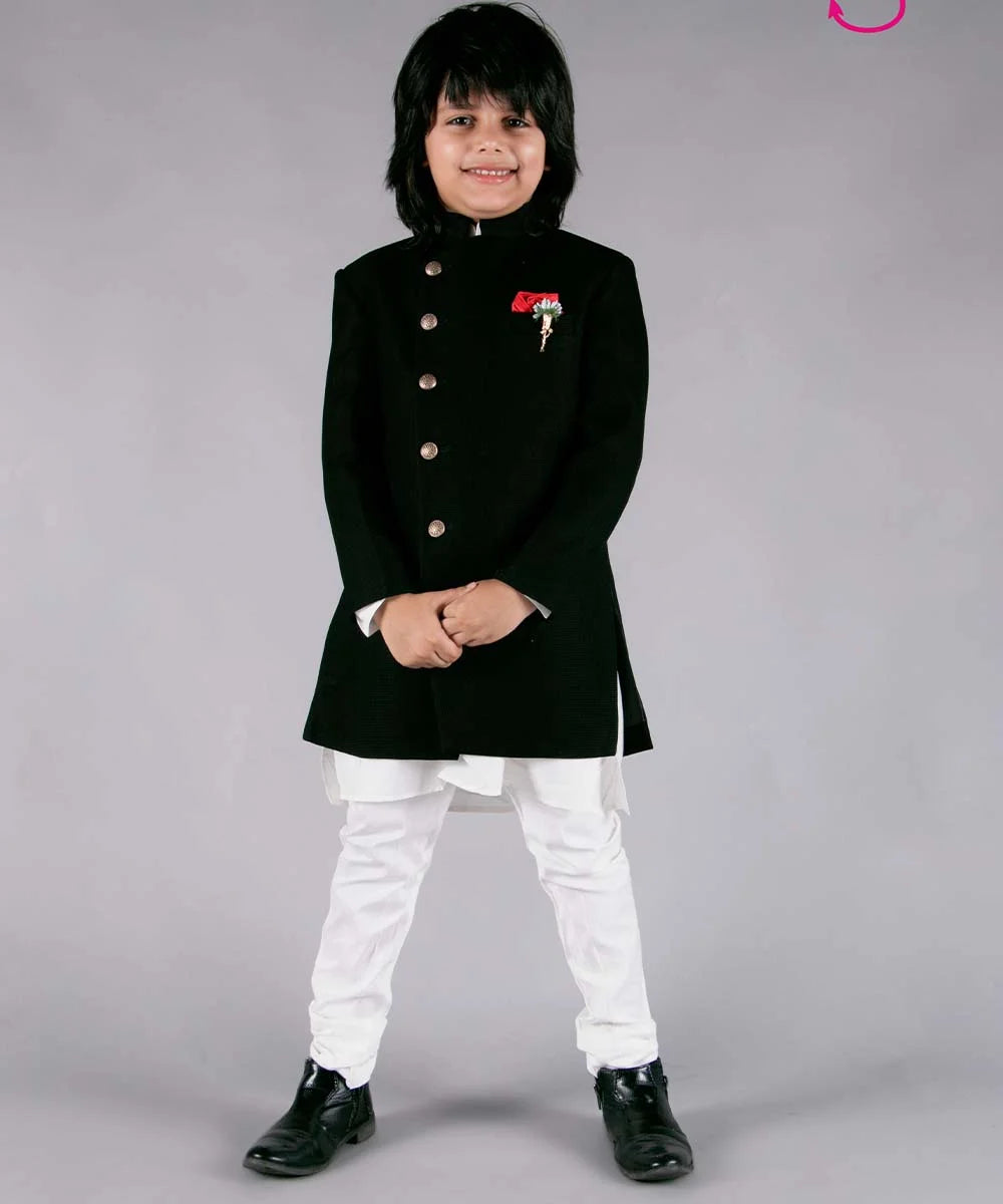 It's a black Colored Jodhpuri suit set that comes with a Nehru collar coat, a white kurta-pajama, a broach and a red-colored pocket square.