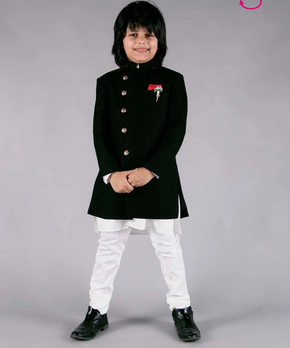 It's a black Colored Jodhpuri suit set that comes with a Nehru collar coat, a white kurta-pajama, a broach and a red-colored pocket square.