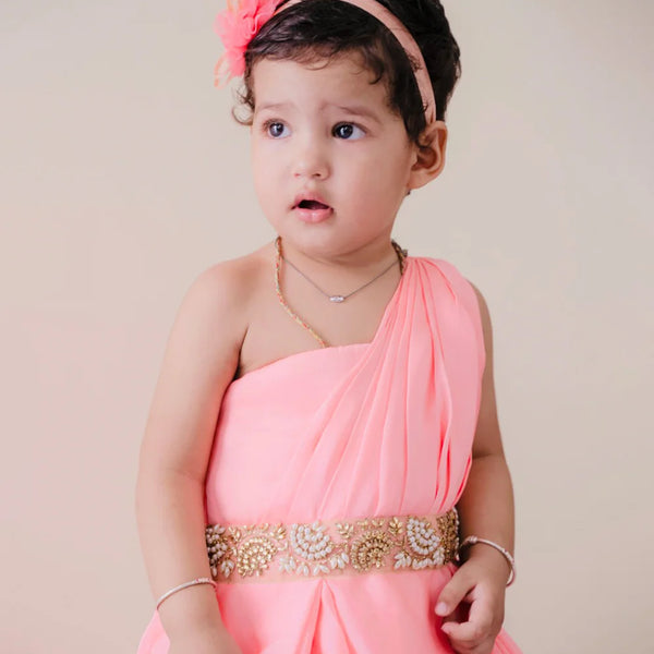  It is a pink Colored gown that comes with back zip closure. It features pearl work and pleated detailing on the dress that uplifts the entire look.