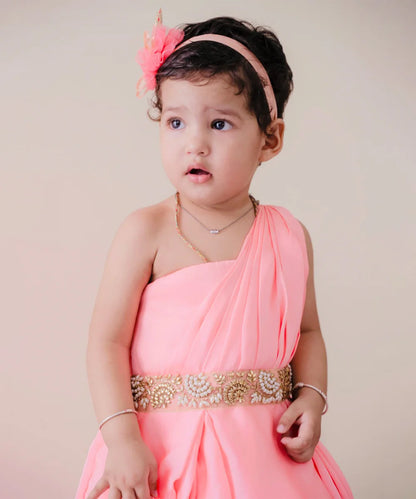  It is a pink Colored gown that comes with back zip closure. It features pearl work and pleated detailing on the dress that uplifts the entire look.