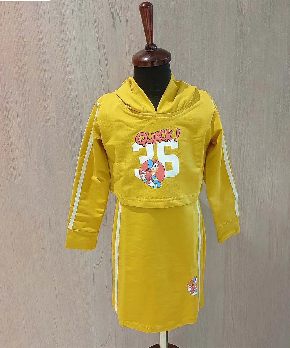  It consists of a straight-fit mustard Colored party dress paired up with a crop top that comes with a hoodie. It features a beautiful Donald duck print on the dress. It’s a 3 in 1 dress as a crop top and straight fit dress both can be styled individually as well.
