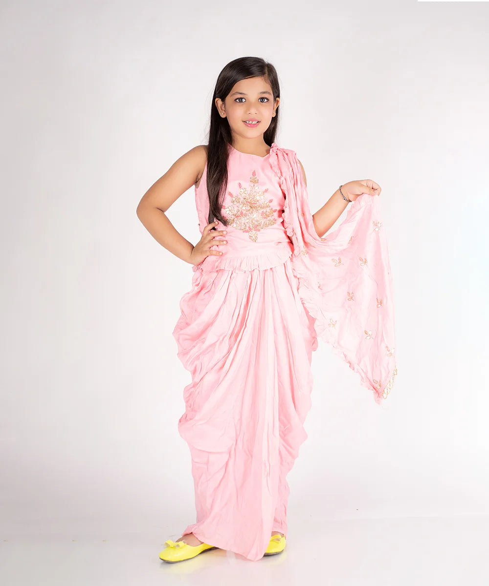  This pink dress consist of a beautiful crop-top and a dupatta attached to the draped dhoti pant perfect for party. It features embellished floral motif on crop top and dupatta.