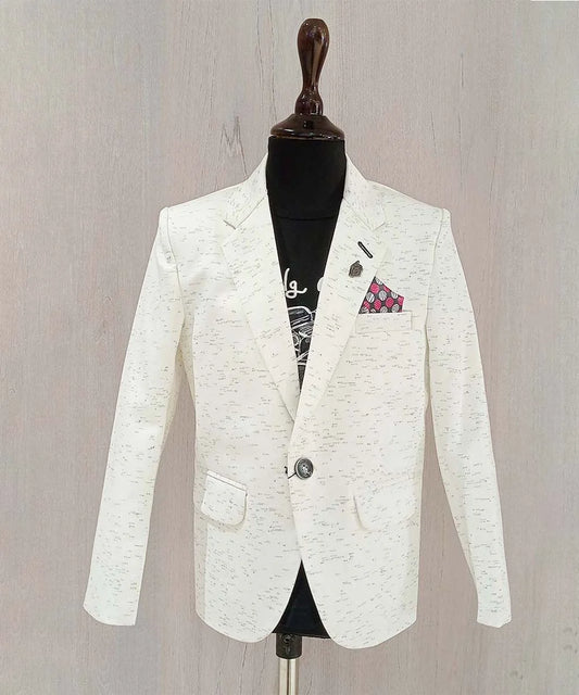 It is a smart cream color textured blazer for your kid boy that comes with a cool black round neck and half sleeved t-shirt. It features a stylized broach on a classic notch lapel collar.