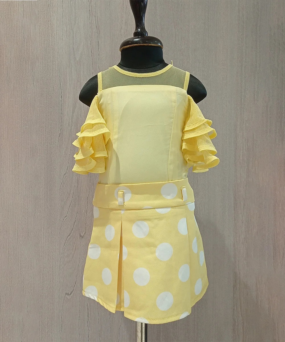 This outfit consists of a top and a Polka dotted box pleat skirt. It has net layer sleeves and zip closure on the top and skirt.