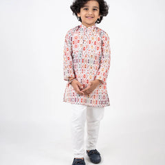 It is a beautiful Patola printed cotton kurta with Nehru collar teamed up with off White Pajama for boys.