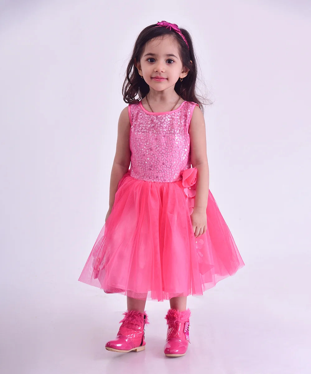 Pink frock that comes with a back zip closure and features sequin and floral detailing on the dress.