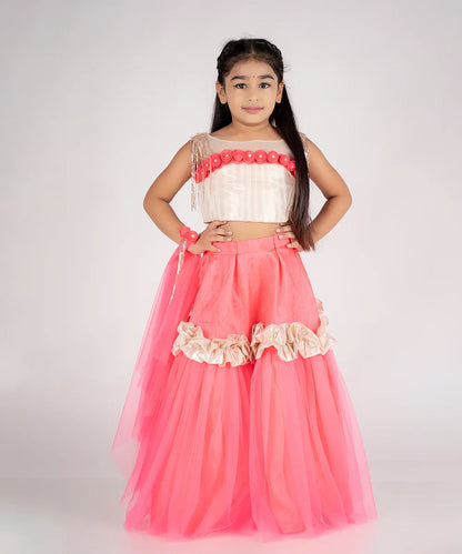 This pink lehenga consist of a choli, a Lehenga and a dupatta for your kids with a back hook closure. It features flower work detailing on choli and dupatta, pleats on choli and ruffled lace on Lehenga.