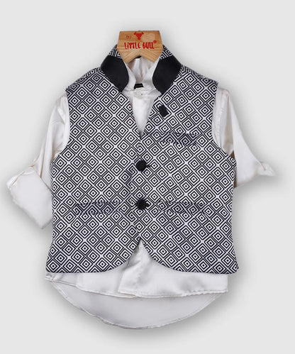 Dress up your little boy in this black & white printed waistcoat set. Crafted in a sleeveless style with button fastening for a secure fit, it features two hand pockets for a classic look. It is paired up with the matching white Colored satin shirt and black Colored trousers 