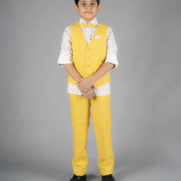 It’s a beautiful yellow Colored waist coat teamed up with a matching pant and a nice printed white Colored shirt. It features a cute bow and a printed pocket square to uplift the entire look.
