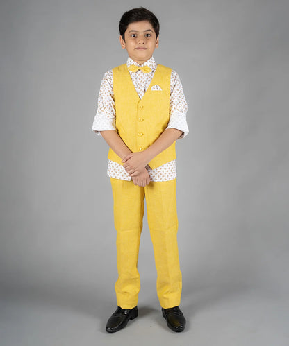 It’s a beautiful yellow Colored waist coat teamed up with a matching pant and a nice printed white Colored shirt. It features a cute bow and a printed pocket square to uplift the entire look.