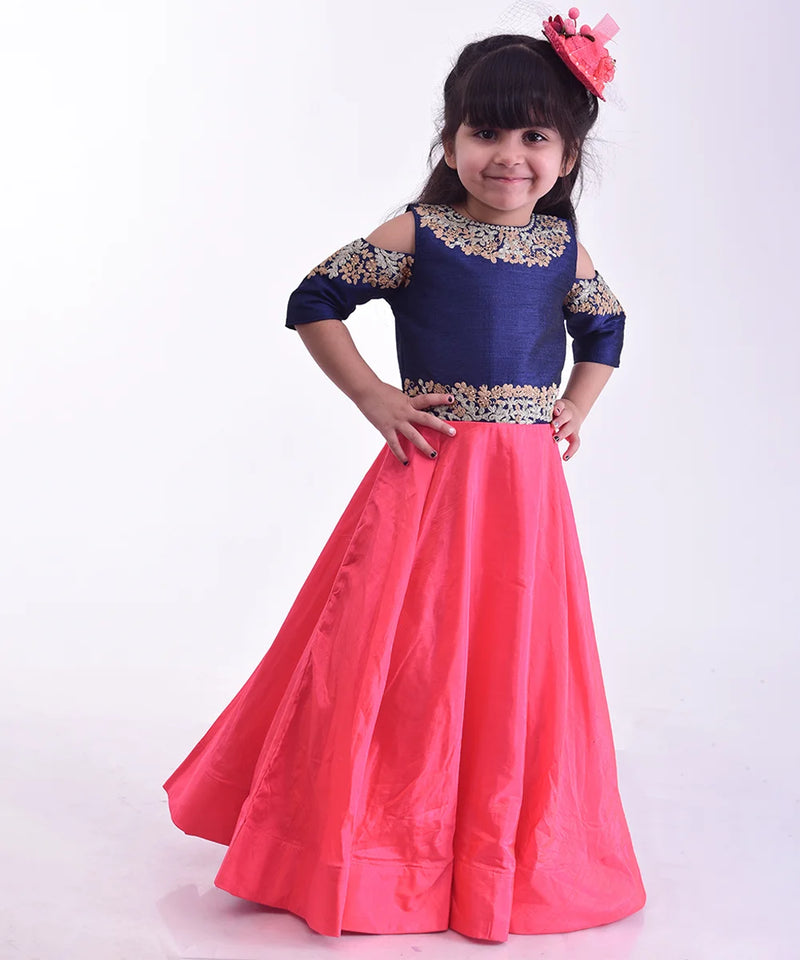 It’s a pink and blue party gown that comes with the back zip closure. It features floral embroidery detailing on the dress and comes with fabric belt to be tied at the back.