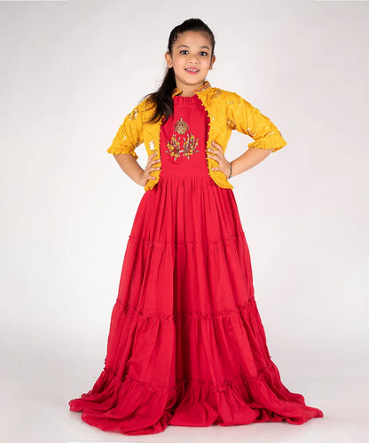  It’s the red and mustard Colored gown that comes with the back zip closure and paired up with an embroidered jacket. It features jacket with a pleated detailing on sleeves. Moreover, beautiful embroidery work is also done on the yoke part of the gown.
