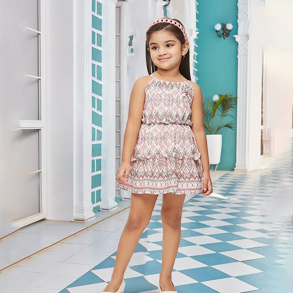 It is a multi Colored self-printed tiered dress that comes with a back zip closure. It’s a trendy dress for kids. It features a cute floral broach detailing.