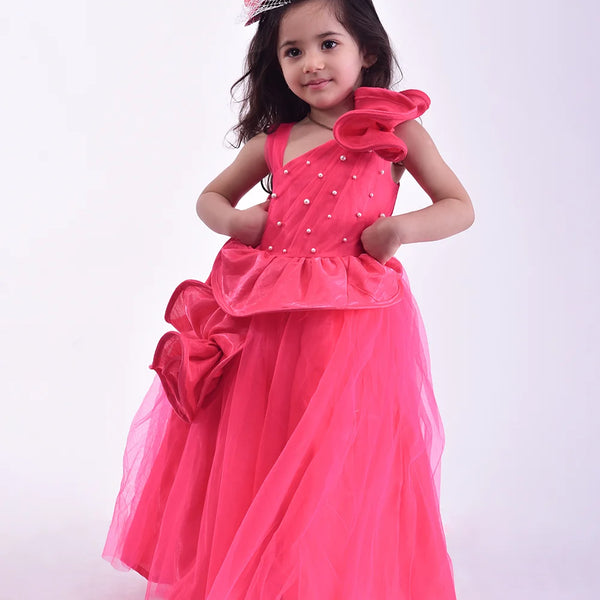 It’s a pink party gown for kids that comes with the back zip closure. It features flounce and pearl work detailing. Moreover, it also has a fabric belt to be tied at the back.