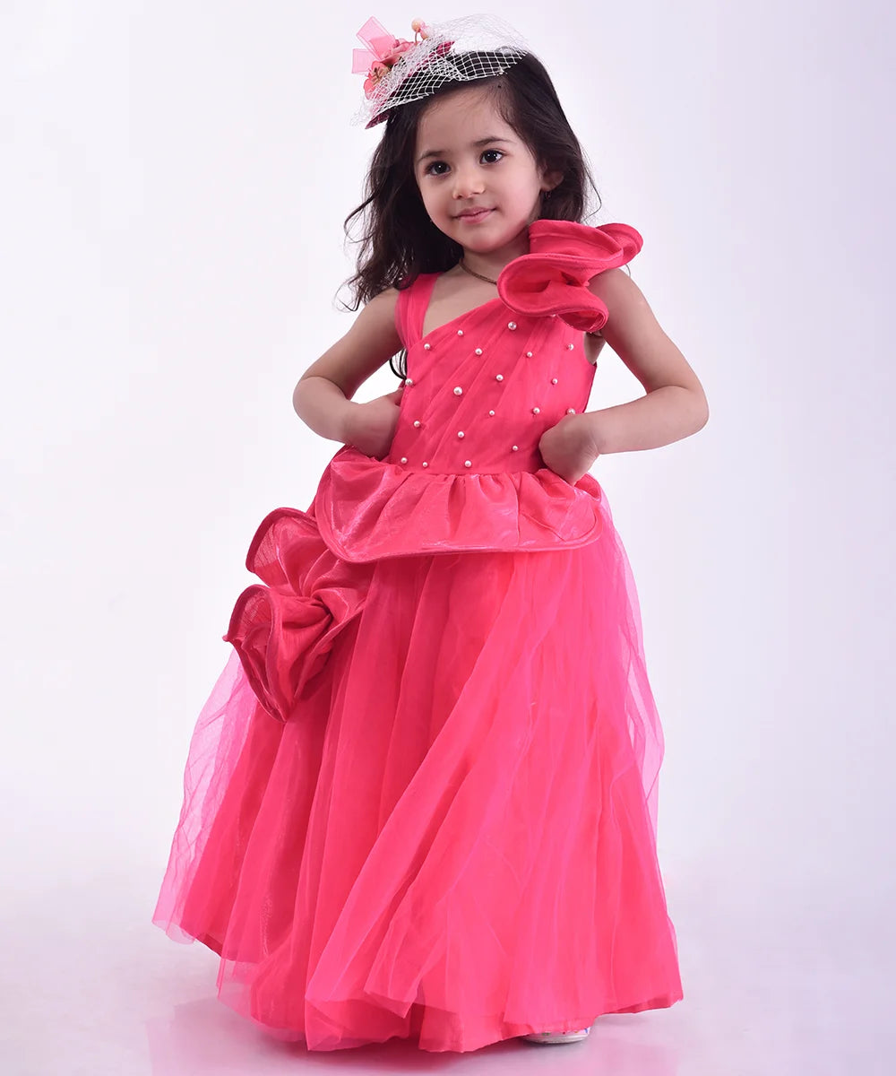 It’s a pink party gown for kids that comes with the back zip closure. It features flounce and pearl work detailing. Moreover, it also has a fabric belt to be tied at the back.