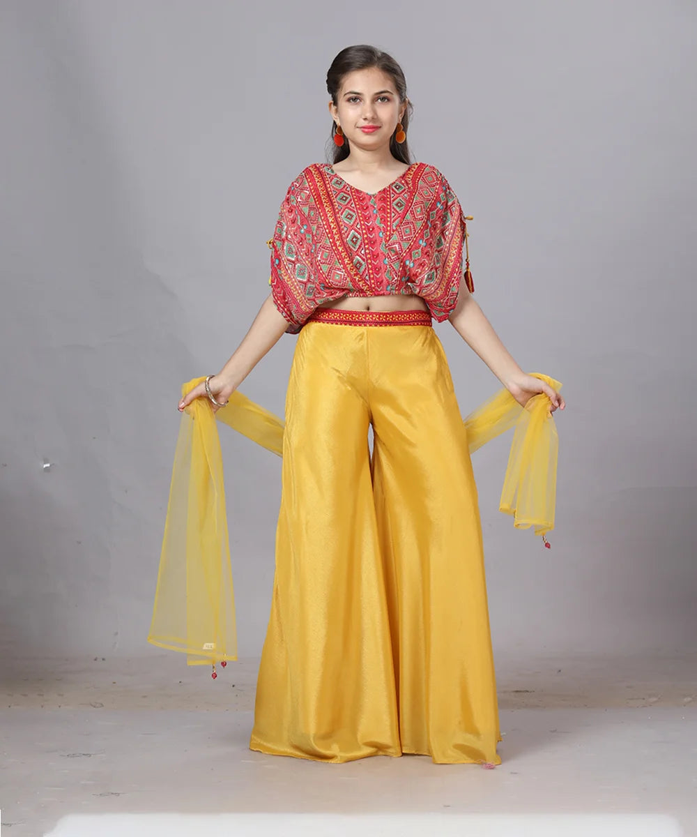 This red and mustard Colored dress consists of a designer crop-top with the back hook closure a dupatta and a palazzo perfect for party looks. It features dori on shoulder and embroidery detailing on all over the top. Moreover, it comes with a basic short sleeves that can be stitched as per requirement.