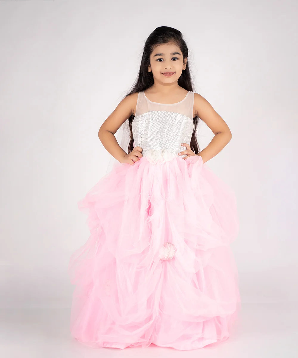 This pink and white Colored gown comes with the back zip closure. It features floral work detailing on the waist and the skirt part. Moreover, it also has a fabric belt to be tied at the back.