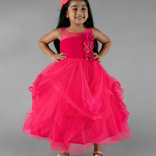 It’s a pink party gown for kid girl that comes with the back zip closure. It features floral as well as feather work on the dress and comes with the fabric belt to be tied at the back.