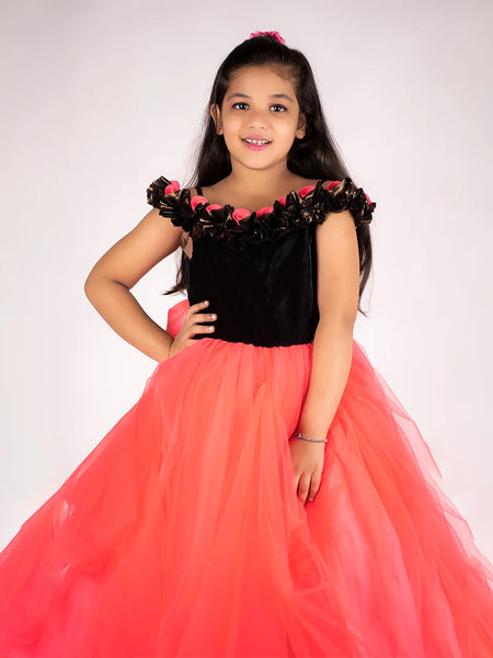 It’s a peach and black Colored gown for girl that comes with the back zip closure. It features floral as well as ruffle detailing on the dress and comes with the fabric belt to be tied at the back.