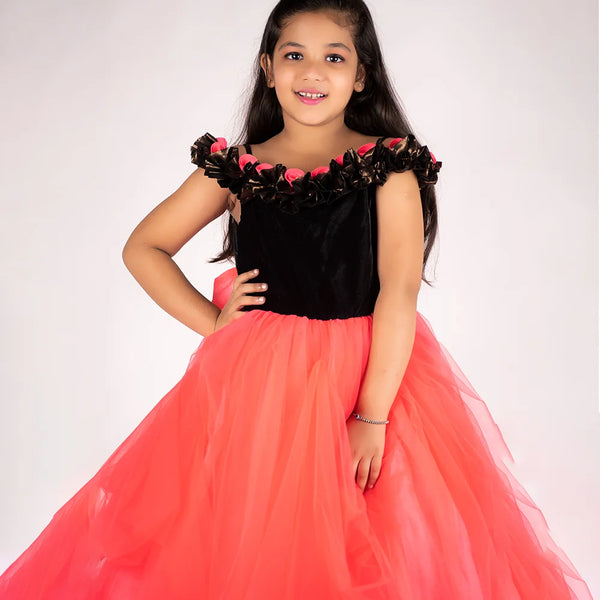 It’s a peach and black Colored gown for girl that comes with the back zip closure. It features floral as well as ruffle detailing on the dress and comes with the fabric belt to be tied at the back.