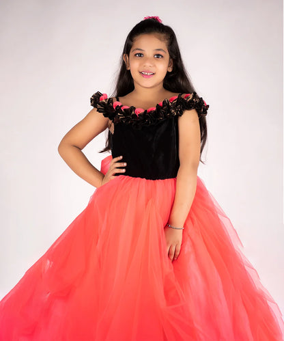 It’s a peach and black Colored gown for girl that comes with the back zip closure. It features floral as well as ruffle detailing on the dress and comes with the fabric belt to be tied at the back.