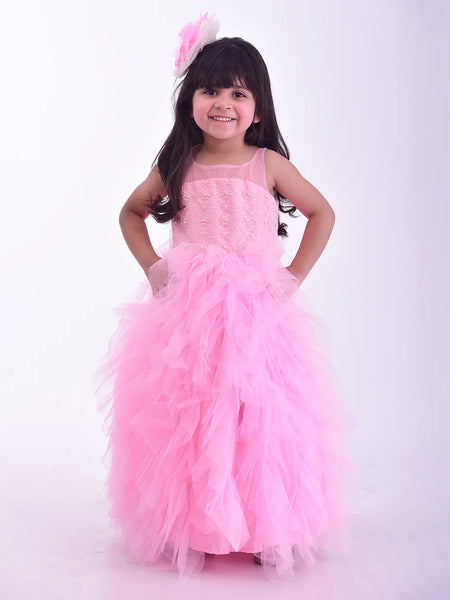  It’s a pink Colored frill birthday gown for kids that comes with the hook closure at the back with pearl detailing on it. It features a big bow at the back, pearl work detailing and comes with the fabric belt to be tied at the back.