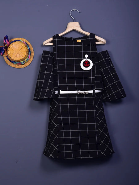  It is a black and white checked dress with a belt. It comes with a cute broach and a belt with a written inscription on it.
