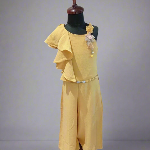 It is a mustard Colored jumpsuit for baby girls and is the best children birthday dress. It comes with a matching belt, ruffled detailing on one shoulder and a star broach detailing.