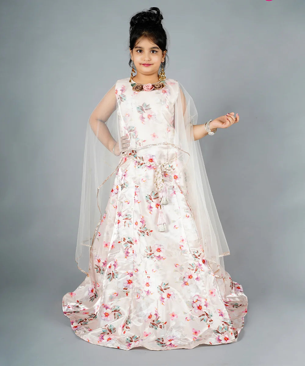 This cream Colored dress consists of a long floral printed gown and a white coloured cape curated from the soft fabric. It features a matching belt and floral detailing on the cape. Moreover, it comes with matching sleeves that can be stitched as per the requirement.