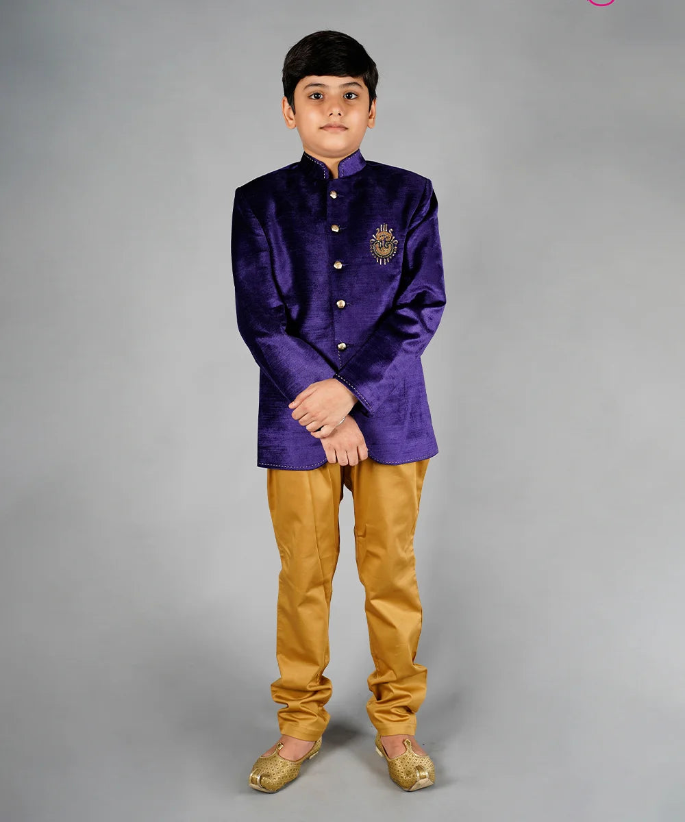 It is a beautiful Purple Velvet Jodhpuri Coat with beige breeches pants and comes with a beautiful embroidery work done on the left side of the chest for wedding party look.