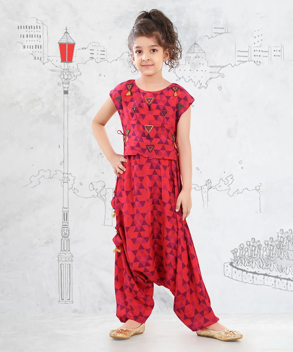 It is a multi Colored self-printed jumpsuit for girls perfect for summer days. It comes with an embroidery work detailing.