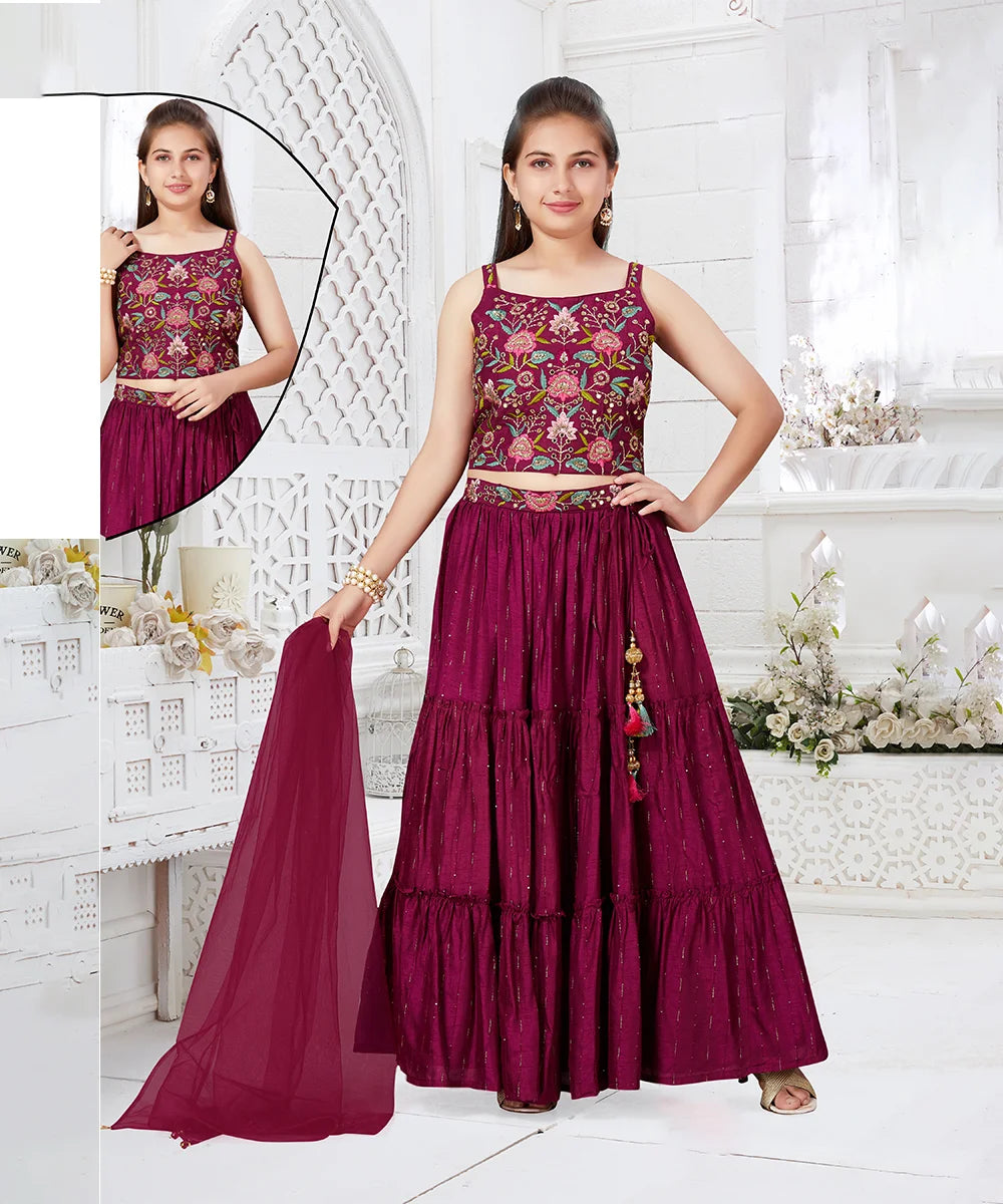 This Magenta outfit consist of an embroidered choli, a tiered Lehenga and a dupatta for your kids with a back hook closure. It features beautiful tassels on the skirt and the outfit comes with the matching sleeves to be stitched as per requirement.