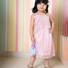 It’s a light pink colored fancy girl dress for weddings with a golden print and an elasticated waist. It features a cute flower attached to the top left side of the dress.