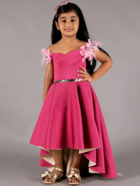 It’s a pink Colored high-low party wear gown for girls with some pleated detailing on it. It features pearl and feather work detailing that adds elegance to the dress.