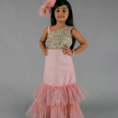 It’s a pink ruffle gown that comes with the back zip closure. It features ruffle detailing and the fabric belt to be tied at the back.