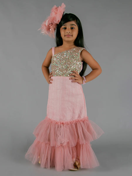 It’s a pink ruffle gown that comes with the back zip closure. It features ruffle detailing and the fabric belt to be tied at the back.