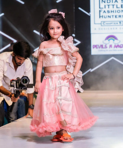 This peach and golden lehenga for girls consist of an off-shoulder choli, a Lehenga and a frilly dupatta for your kids with a back hook closure. It features ruffled neck, skirt with the lace and frill detailing.