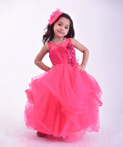 It’s a pink party gown for kid girl that comes with the back zip closure. It features floral as well as feather work on the dress and comes with the fabric belt to be tied at the back.