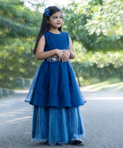 It’s the blue Colored gowns for kids that comes with the back zip closure. Moreover, it is paired up with short sleeves that can be stitched as per requirement. It features embroidery work on the waist, the fabric belt to be tied at the back and a self-embroidered fabric.